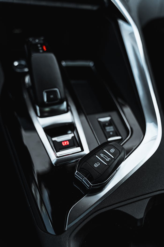 mobile-01 Close-up of a car's modern interior showing the shifter and key fob.