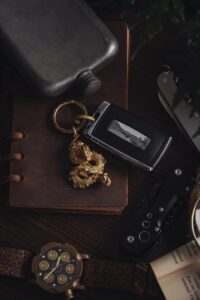 Elegant rustic arrangement of car key, dragon pendant, and vintage accessories.