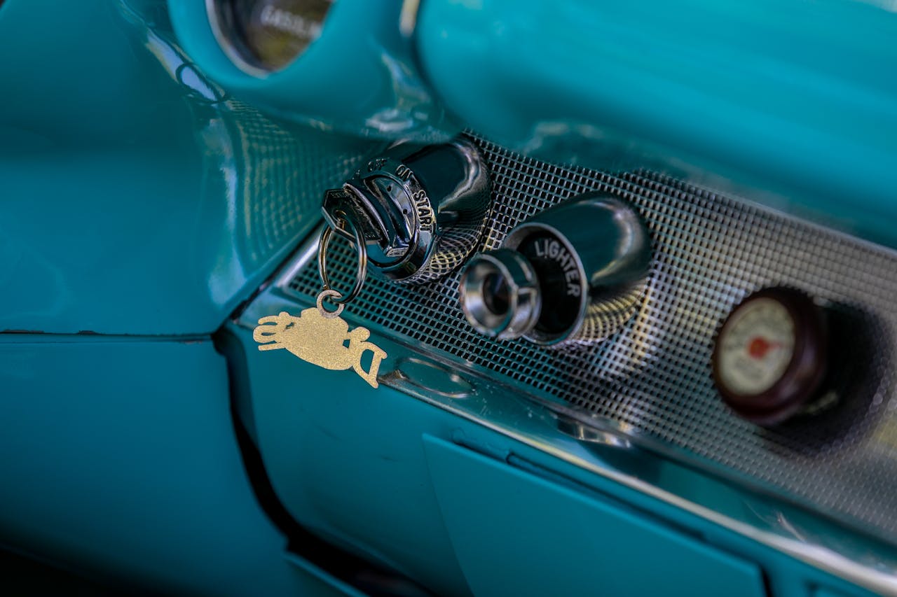 Close-up of a vintage car's ignition and lighter, showcasing classic design.